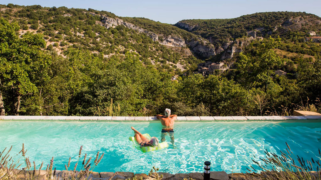 Famille profitant d'une piscine chauffée au printemps dans un jardin français